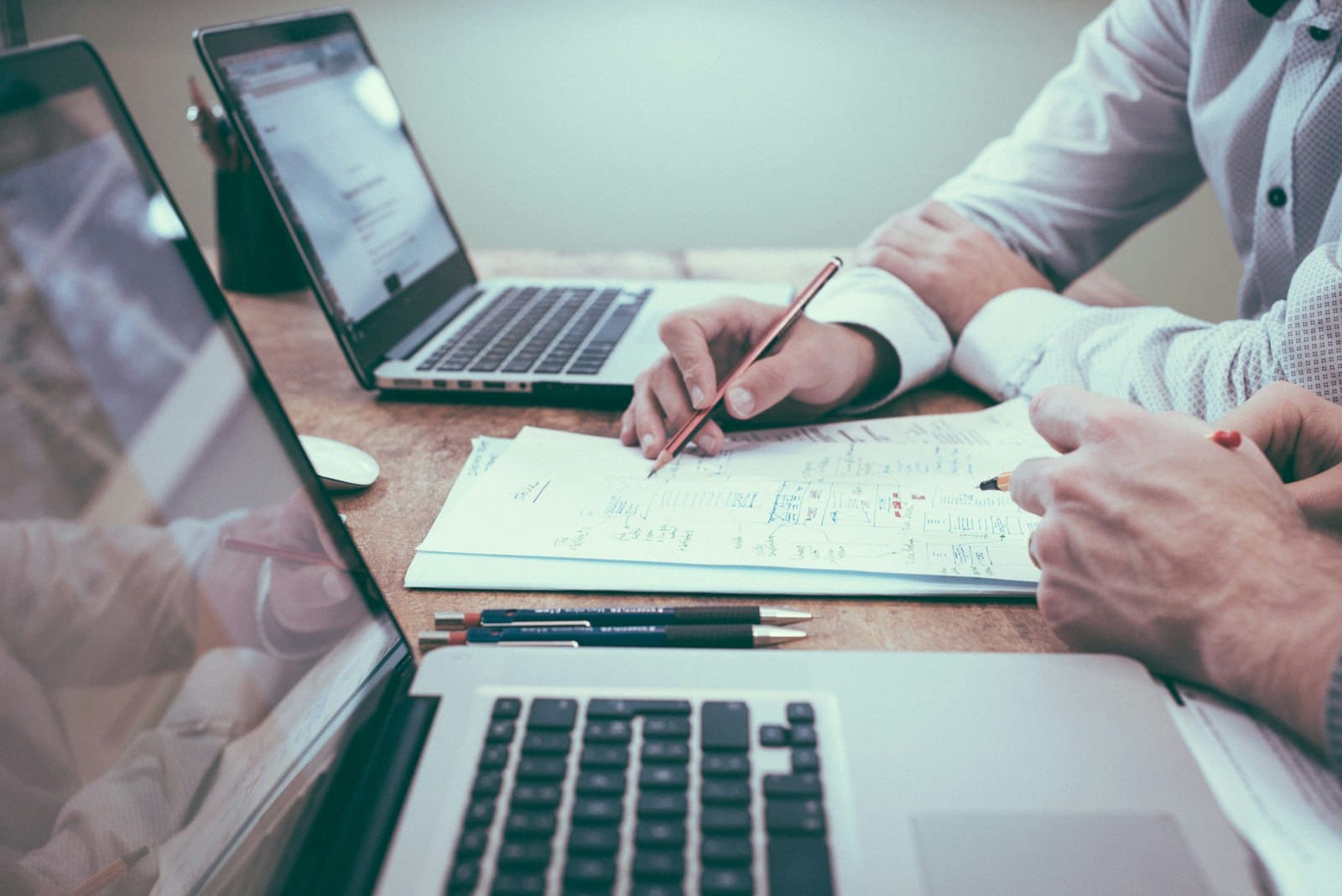 Strategy documents and a laptop on a desk